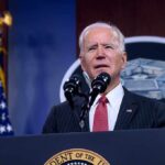 Biden speaking at a microphone
