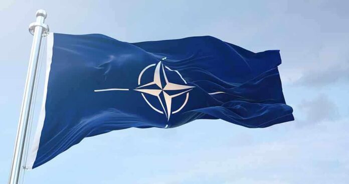 1633919905 featured image NATO flag waving against blue sky.