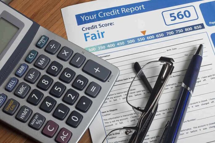 243901528 featured image Calculator and glasses on credit report document