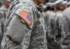 People in camouflage uniforms with US flag patch