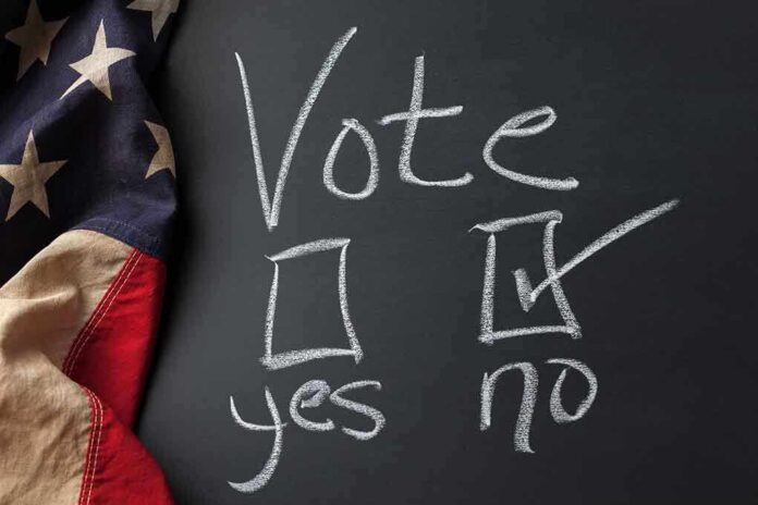 1071657140 featured image Chalkboard vote choice, "no" checked, American flag visible.