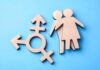 Wooden gender symbols on a blue background