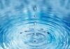 Water droplets creating ripples in a pool