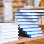 Stack of books on a wooden table indoors