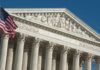 US Supreme Court building with American flag