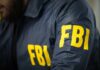 Person wearing FBI jacket with yellow lettering