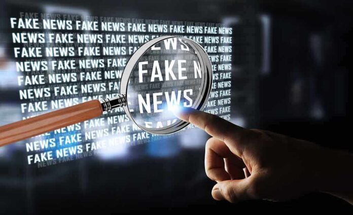 668033083 featured image Hand pointing at fake news through magnifying glass