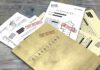 Classified documents with Top Secret stamps on wooden surface.
