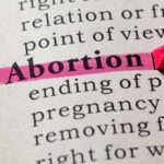 Abortion highlighted in a dictionary with a pink marker.