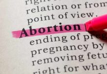 Abortion highlighted in a dictionary with a pink marker.