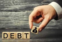 Hand replacing debt block with money symbol block
