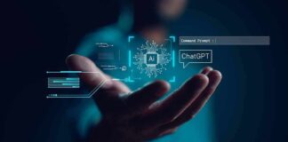 Hand holding digital AI and ChatGPT graphics.