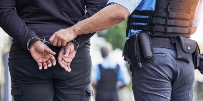 2330146995 featured image Police officer handcuffing person outdoors