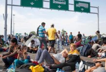 People sitting and resting on a highway.