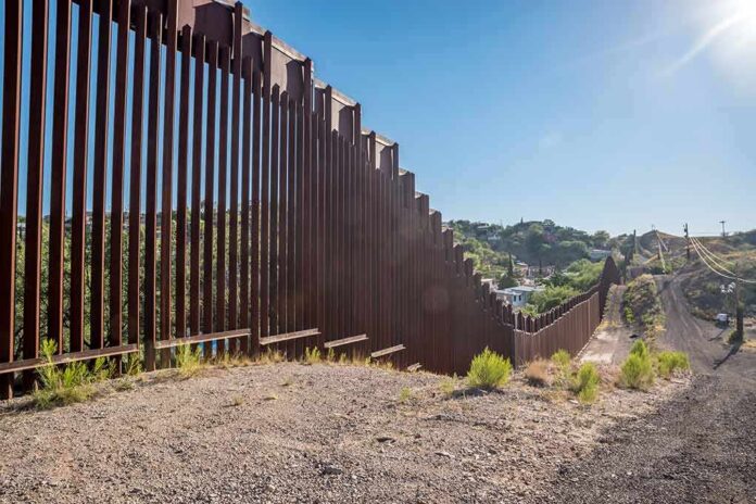 657897121 featured image Tall metal border fence in desert landscape sunlight