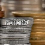 Financial Privacy in Relationships: Unraveling Hidden Savings and Trust Dynamics Stack of coins labeled funding with other coins stacks