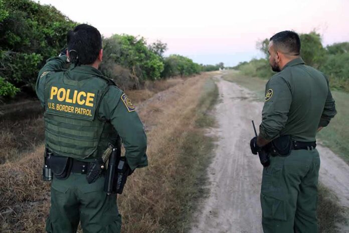2079342073 featured image Two U.S. Border Patrol officers observing a dirt path