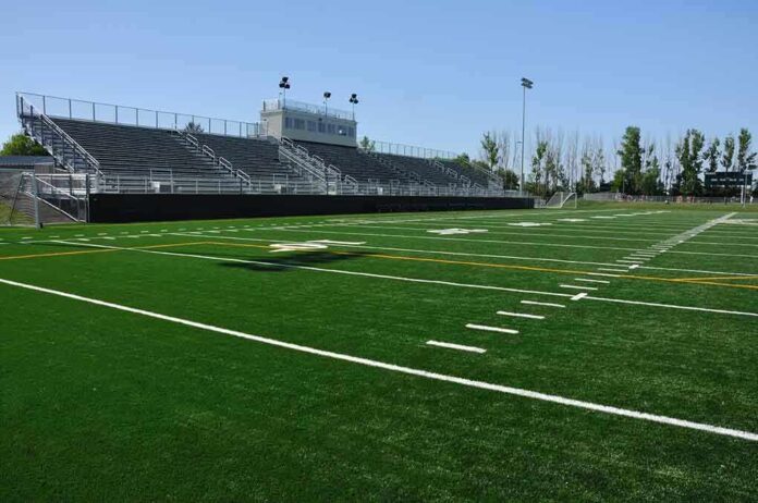 55132081 featured image Empty football field with bleachers in background
