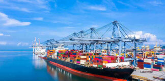 Container ship docked at a busy industrial port