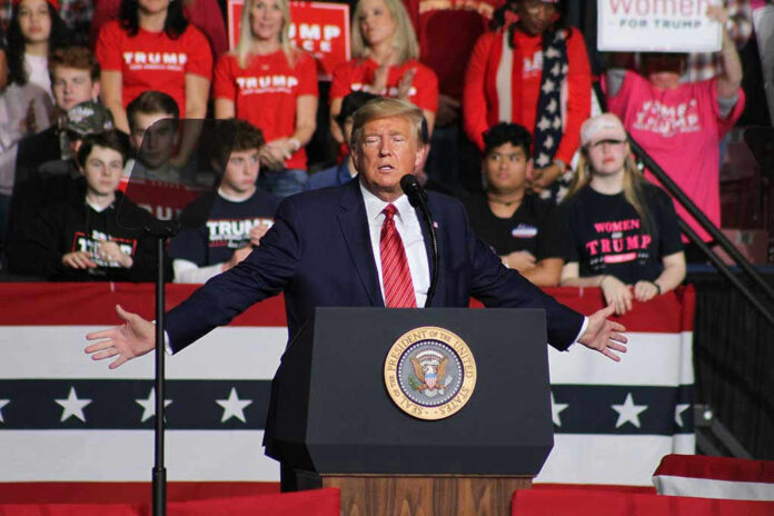 1662925921 Politician speaking at rally with supporters behind him