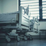 Empty hospital beds by a window