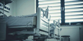 Empty hospital beds by a window