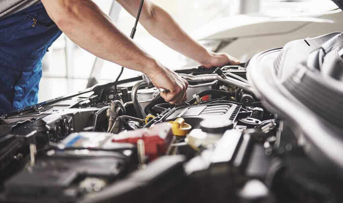 Mechanic working on an engine in a car