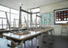 Empty classroom with chairs on top of desks