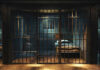 Empty prison cell with metal bars and bed