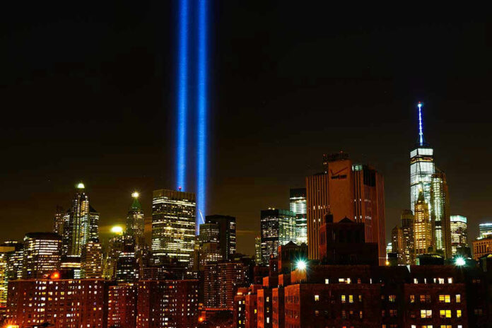 New York City skyline at night with memorial lights