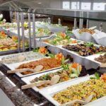 Food Scientists HIJACK Brains — SABOTAGED A buffet table displaying a variety of colorful dishes and salads