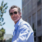 Man in sunglasses wearing a blue button up shirt