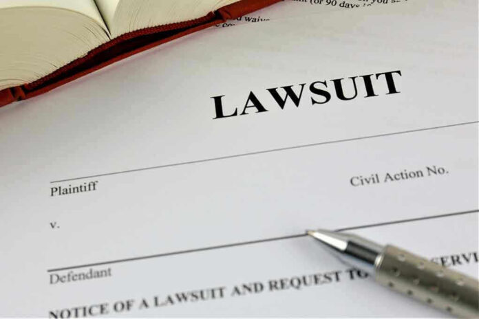 Lawsuit paperwork with pen and open book