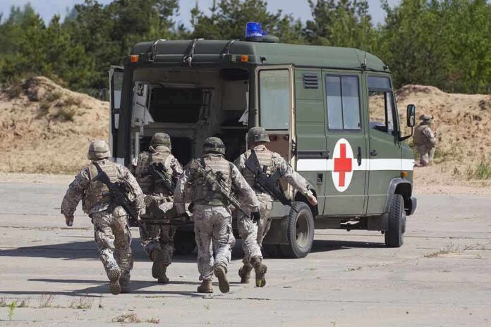 Soldiers running towards a medical vehicle during a military operation