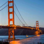 Golden Gate Bridge at dusk with lights on