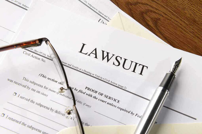 Lawsuit papers with glasses and pen on table