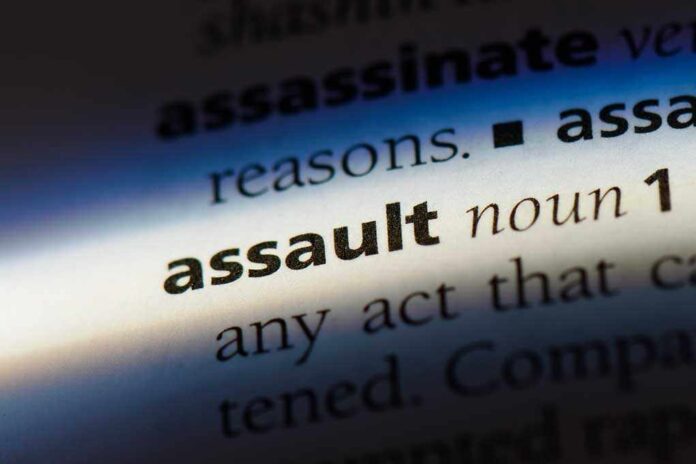 Close-up of a dictionary page showing the definition of the word assault