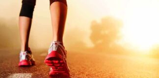 Person jogging on a road during sunrise
