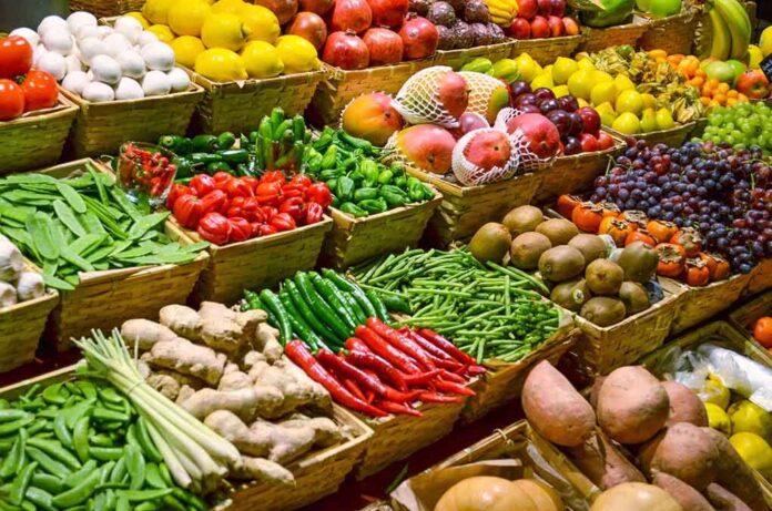 A vibrant display of assorted fruits and vegetables in baskets at a market