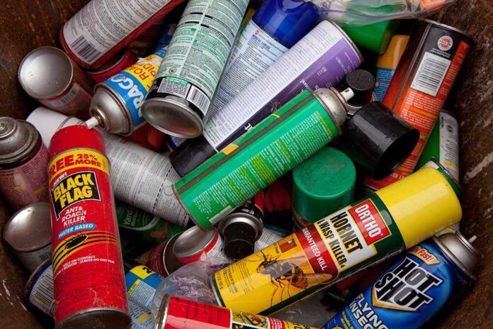 shutterstock_168821852.jpg A pile of discarded spray cans in a garbage bin
