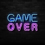 Game Over neon sign on brick wall.