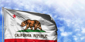 California Republic flag waving against blue sky.
