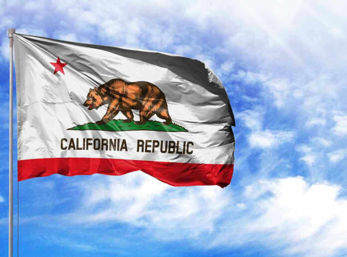 California Republic flag waving against blue sky.