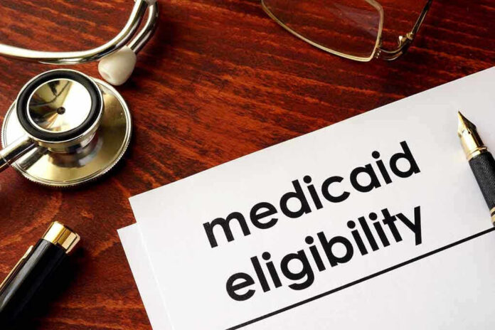 Stethoscope pen document about Medicaid eligibility on table