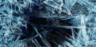 Abstract ice patterns on a dark surface