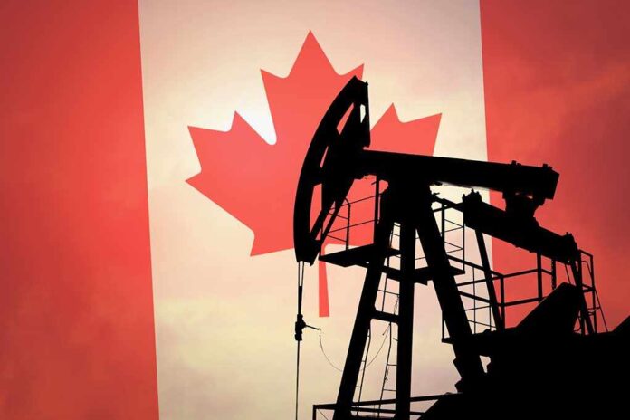 Silhouette of an oil rig against the Canadian flag