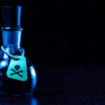 Toxic Attack Rocks Trump-Kennedy Center Dark bottle with skull-and-crossbones label on table.
