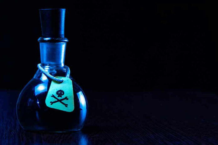 Dark bottle with skull-and-crossbones label on table.