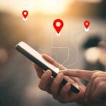 Political Scandal: Affair, Suicide, and Power Abuse Person using a smartphone with location markers displayed on the screen