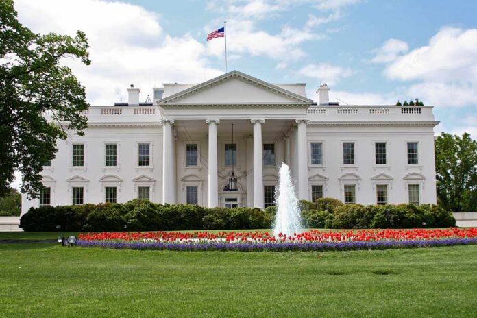 shutterstock_71114719.jpg The White House surrounded by colorful flower beds and a fountain